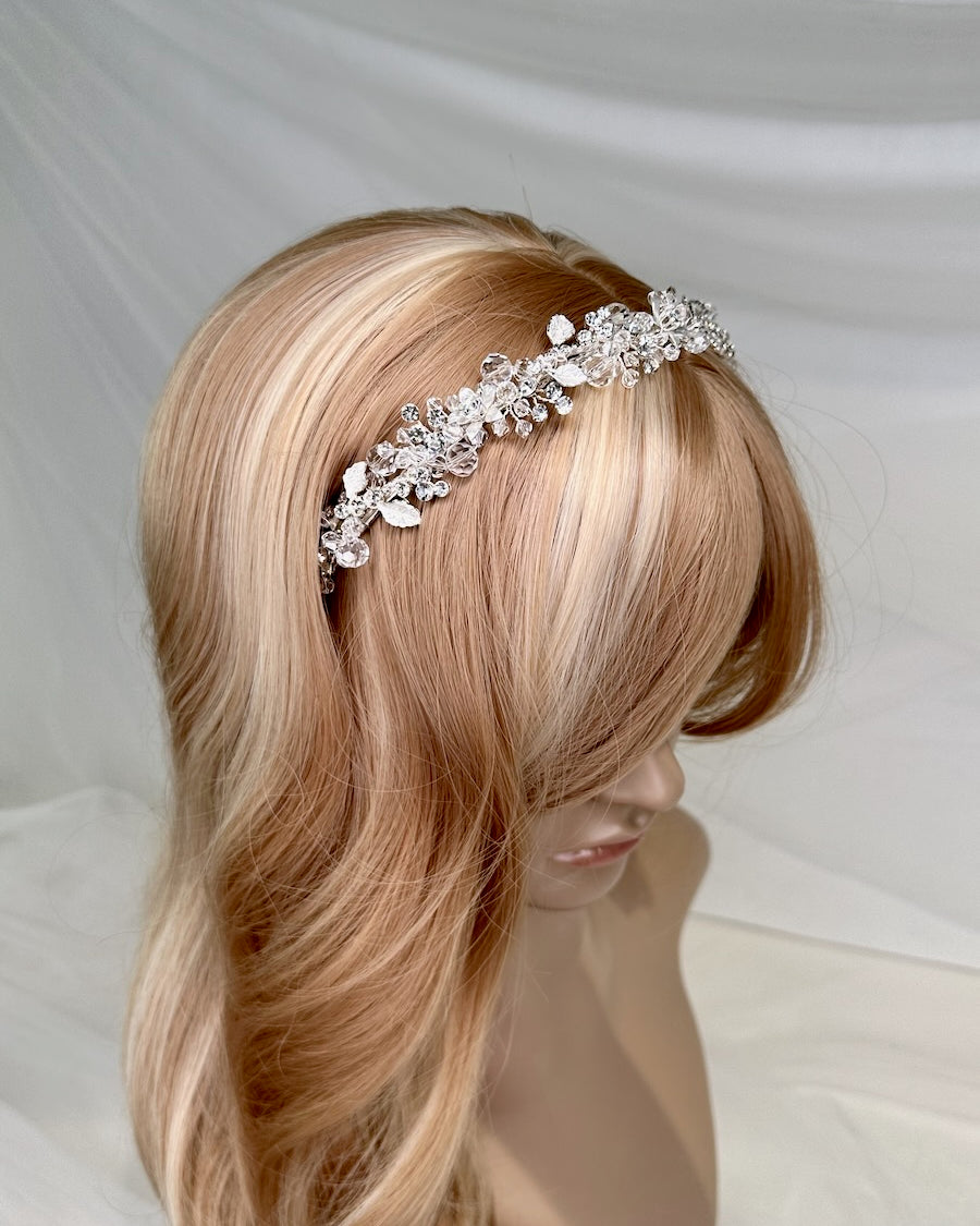 A modern silver crystal headpiece worn on a model head
