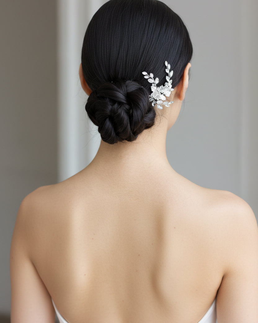 Woman with braided hair adorned with a decorative hairpiece against a neutral background