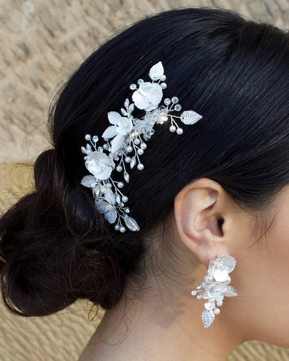 Silver and pearl hair comb with clip fitting with matching earring on dark hair