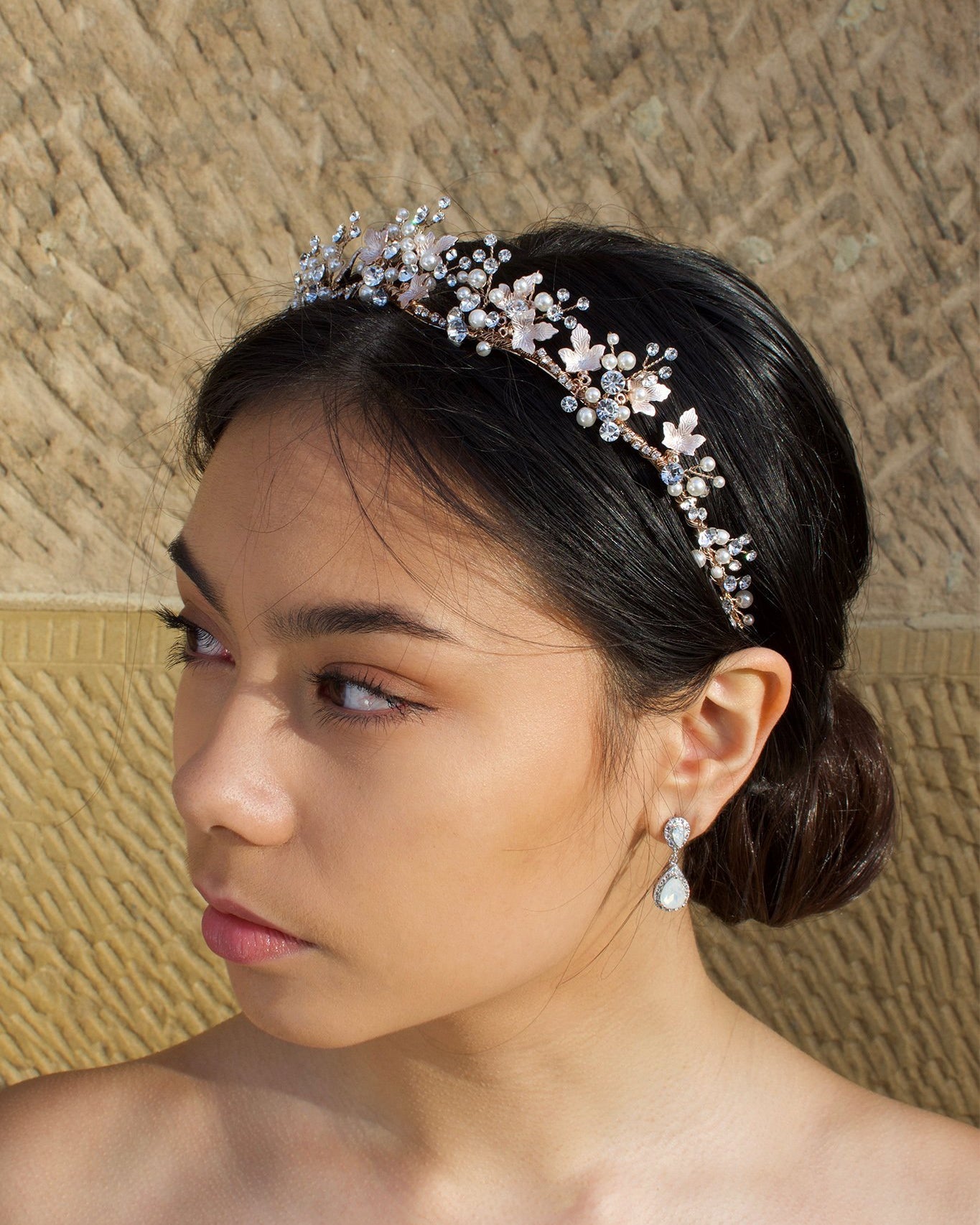 Low Bridal Crown in Rose Gold with pearls and stones worn by dark haired model