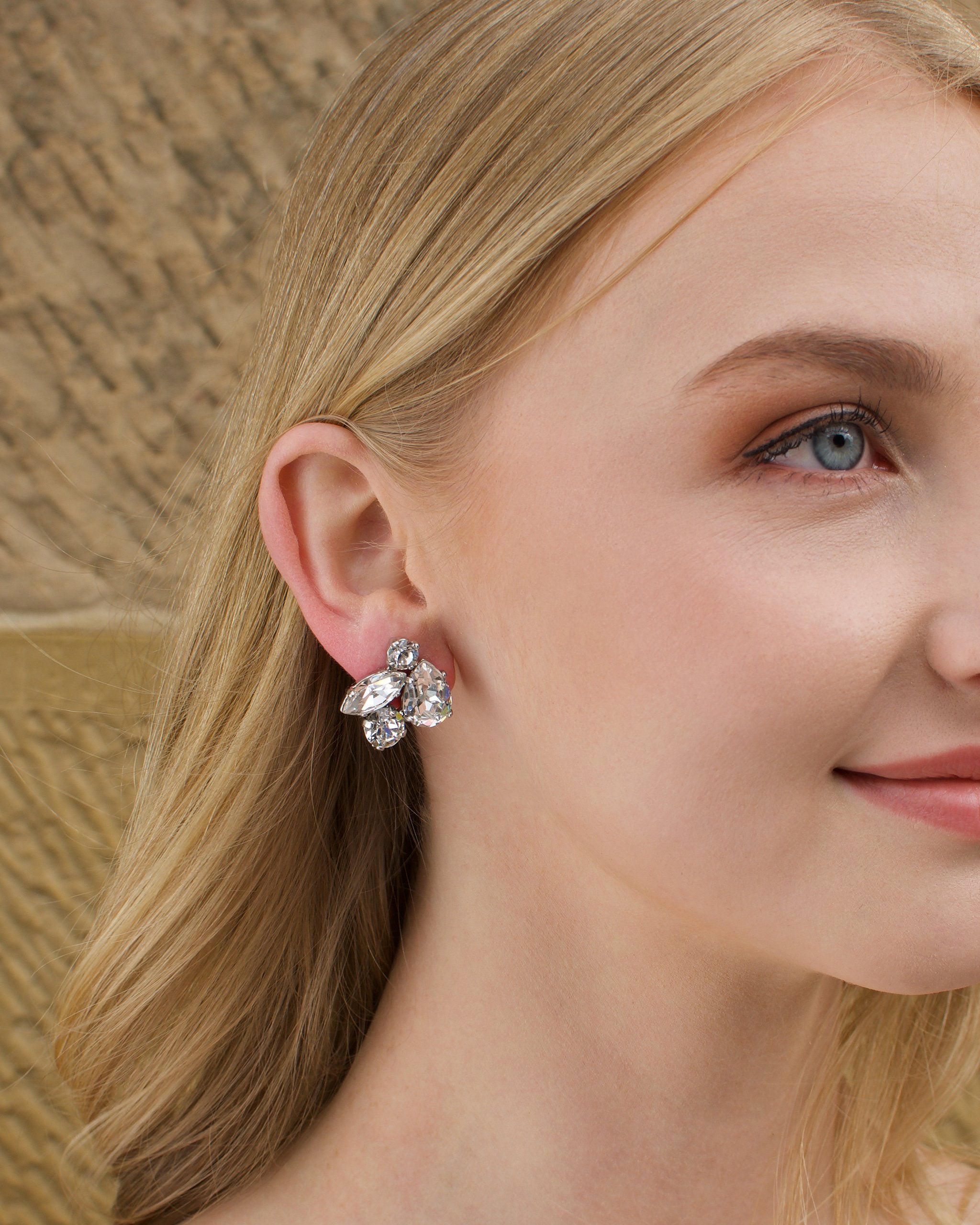 Swarovski Bridal Earring with stones of different shapes worn by a blonde bride