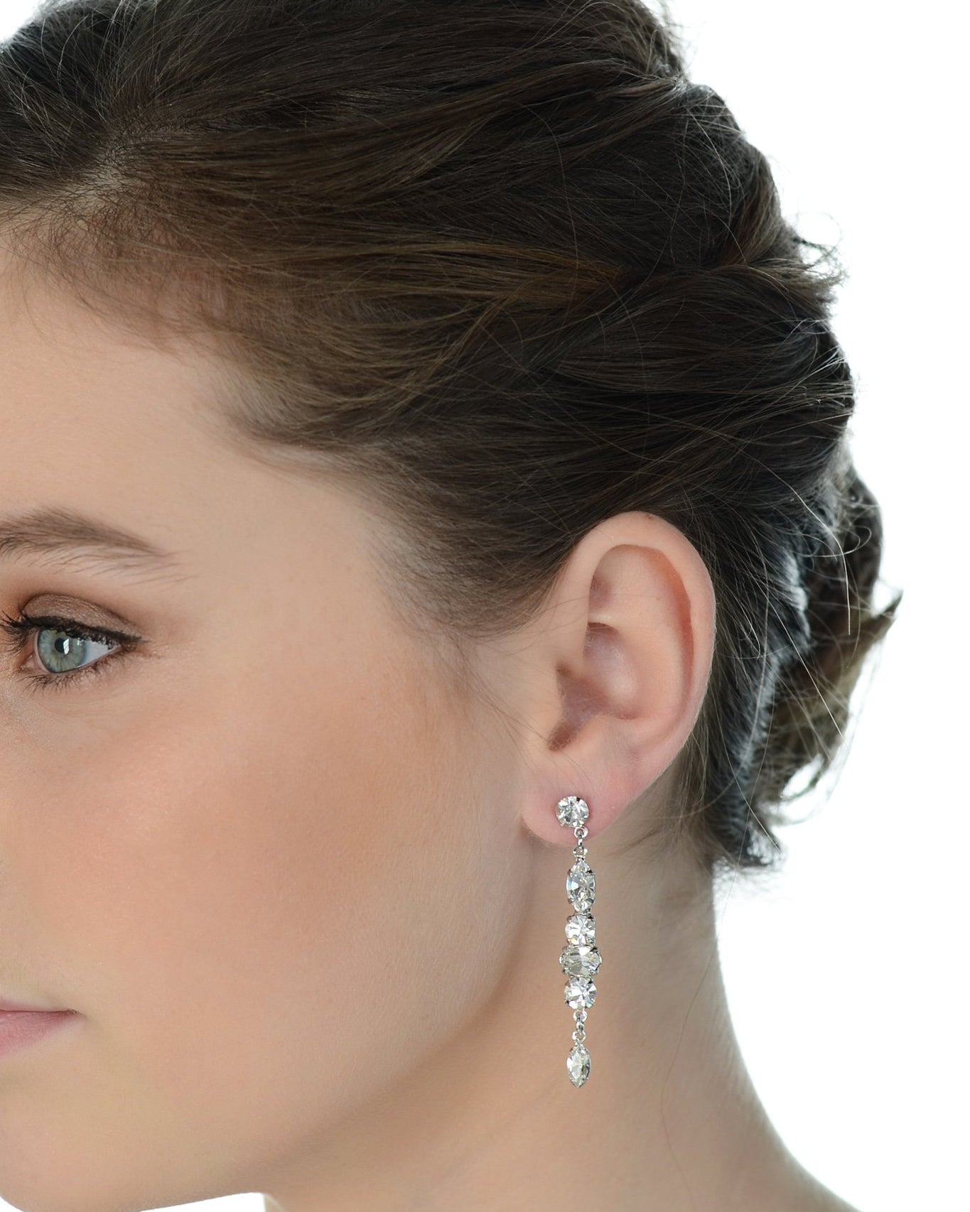 A model wears a long thin bridal earring with a white background