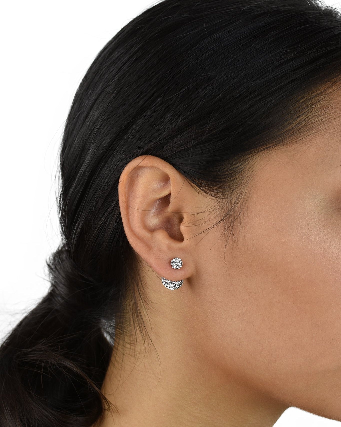 Dark hair model with pony tail hairstyle wears a double crystal ball earring