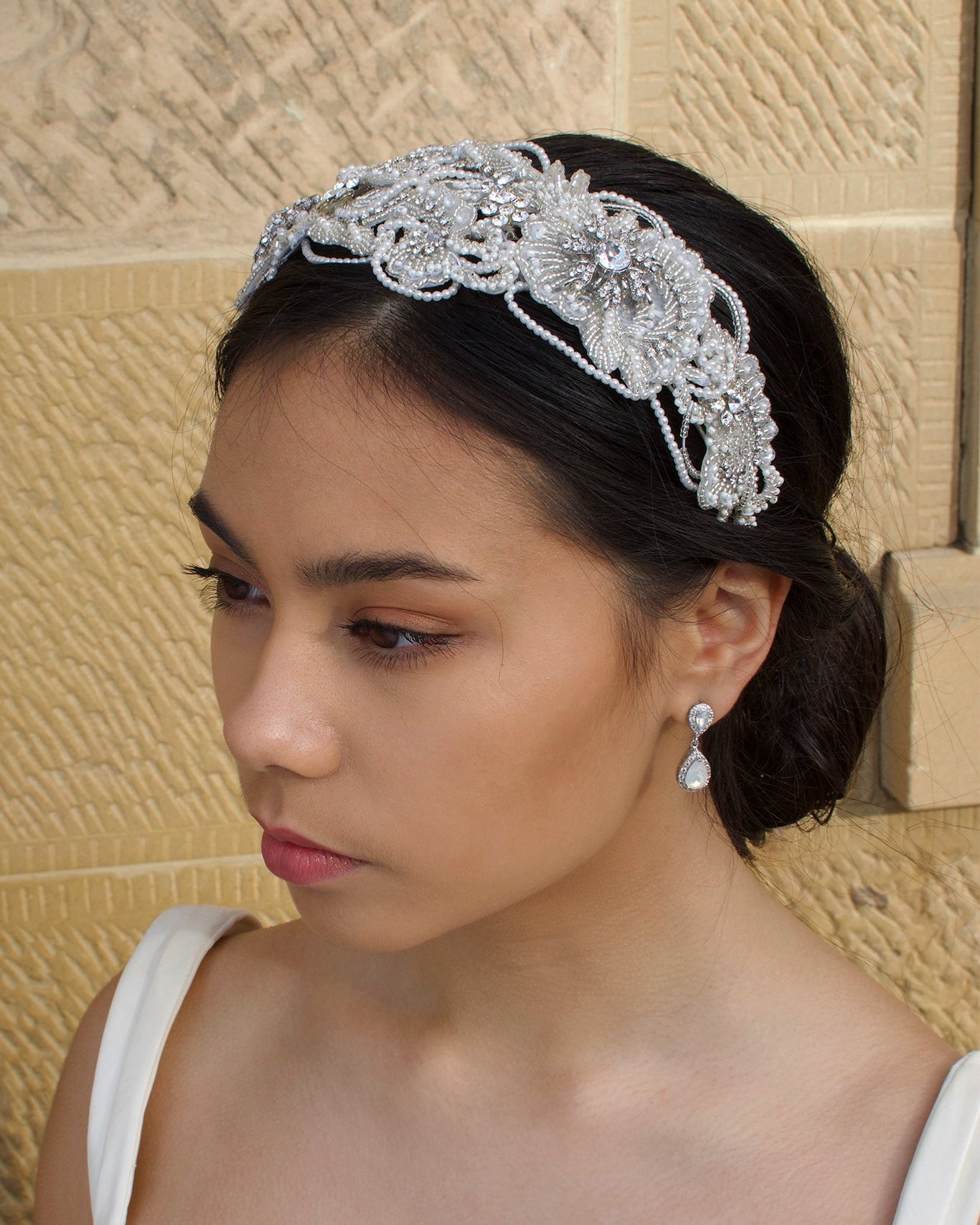 Wide Pearl Bridal Headband worn by a dark bridal model with a sandstone backdrop
