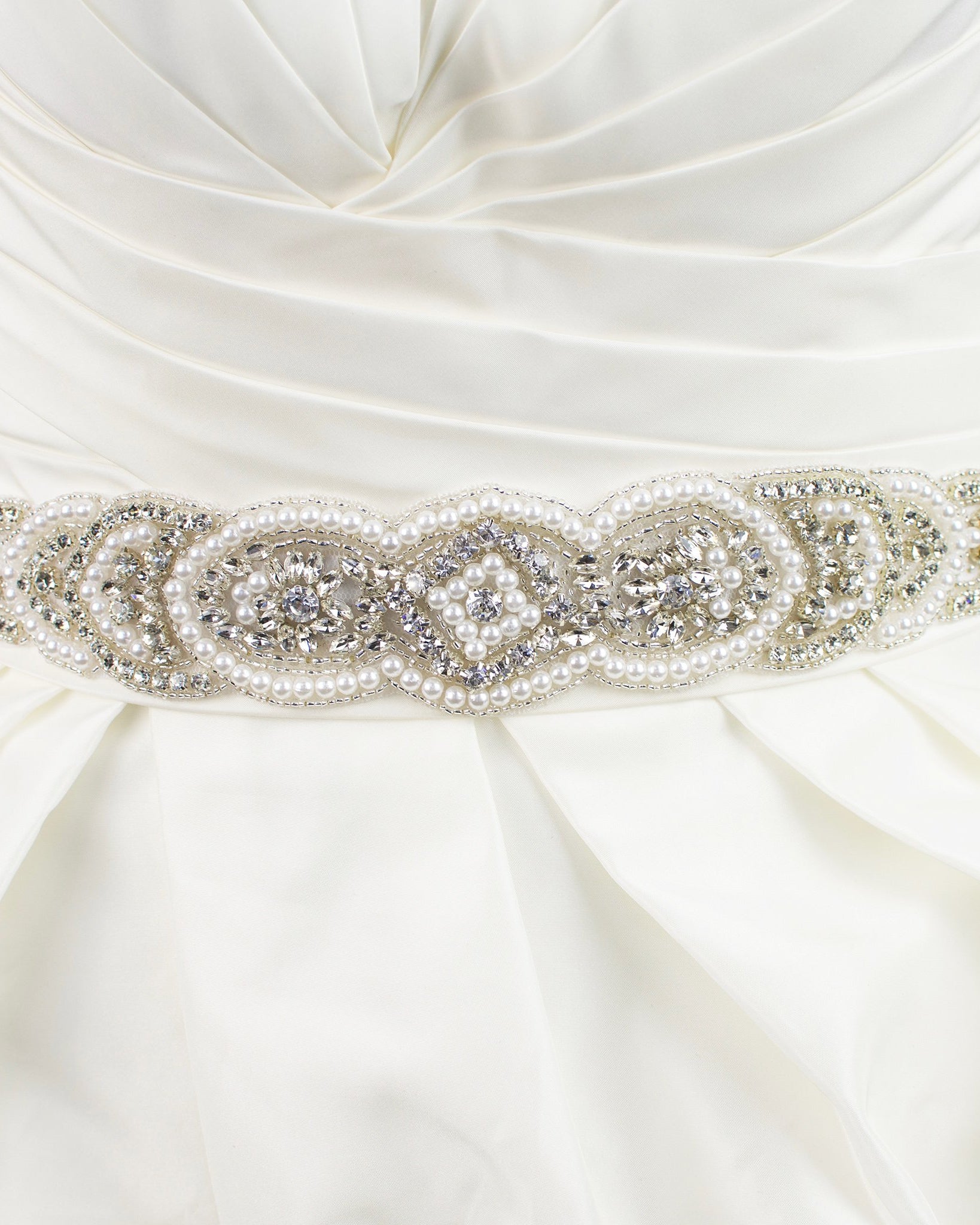 Pearl Bridal Belt Abigail shown on ivory satin ribbon on a plain bridal gown.