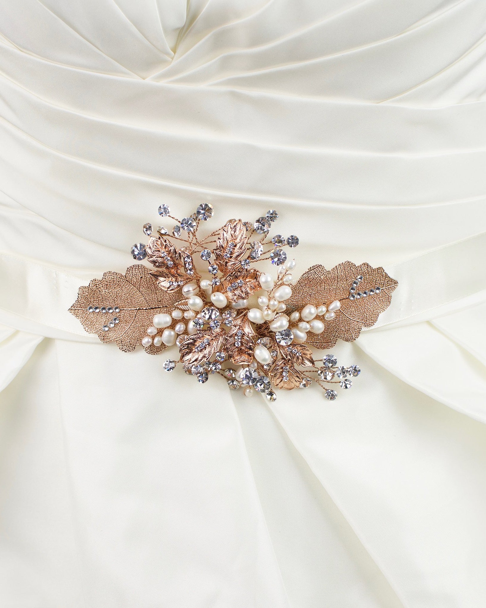 Rose Gold Leaves Motif on an ivory satin ribbon worn on an ivory satin bridal gown