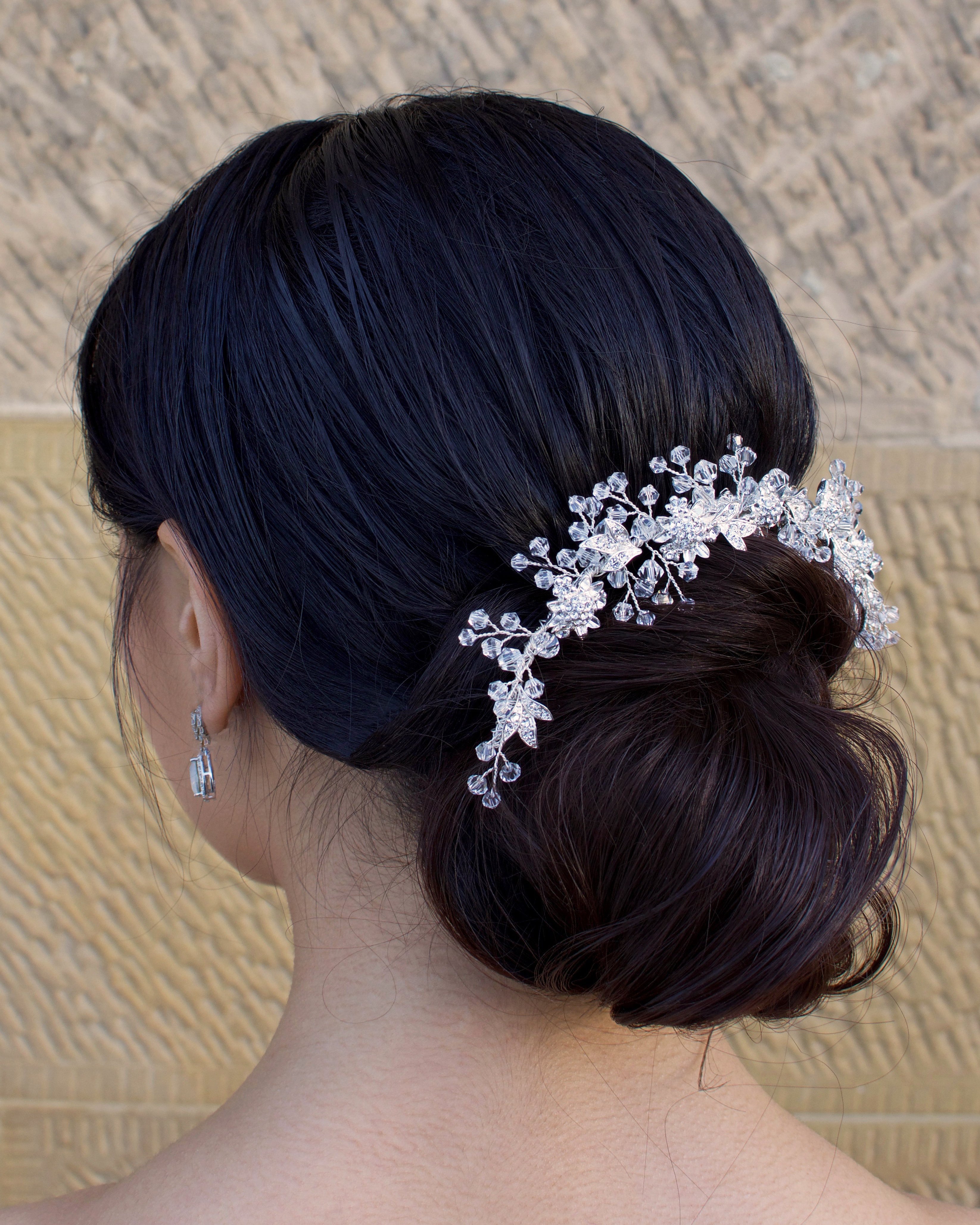 Clear crystal and silver short hair vine worn by a dark haired bride