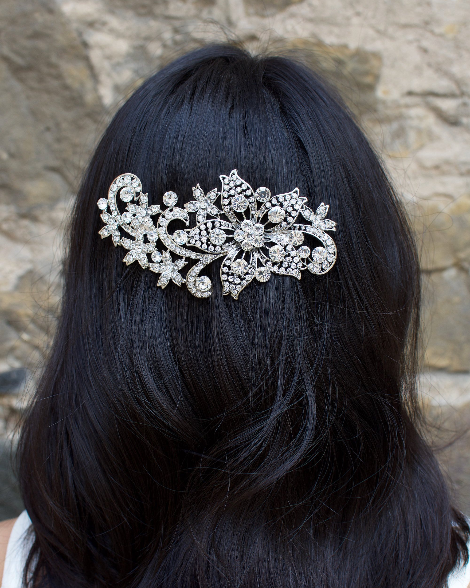 Dark hair model with her hair down wears a dark silver comb.