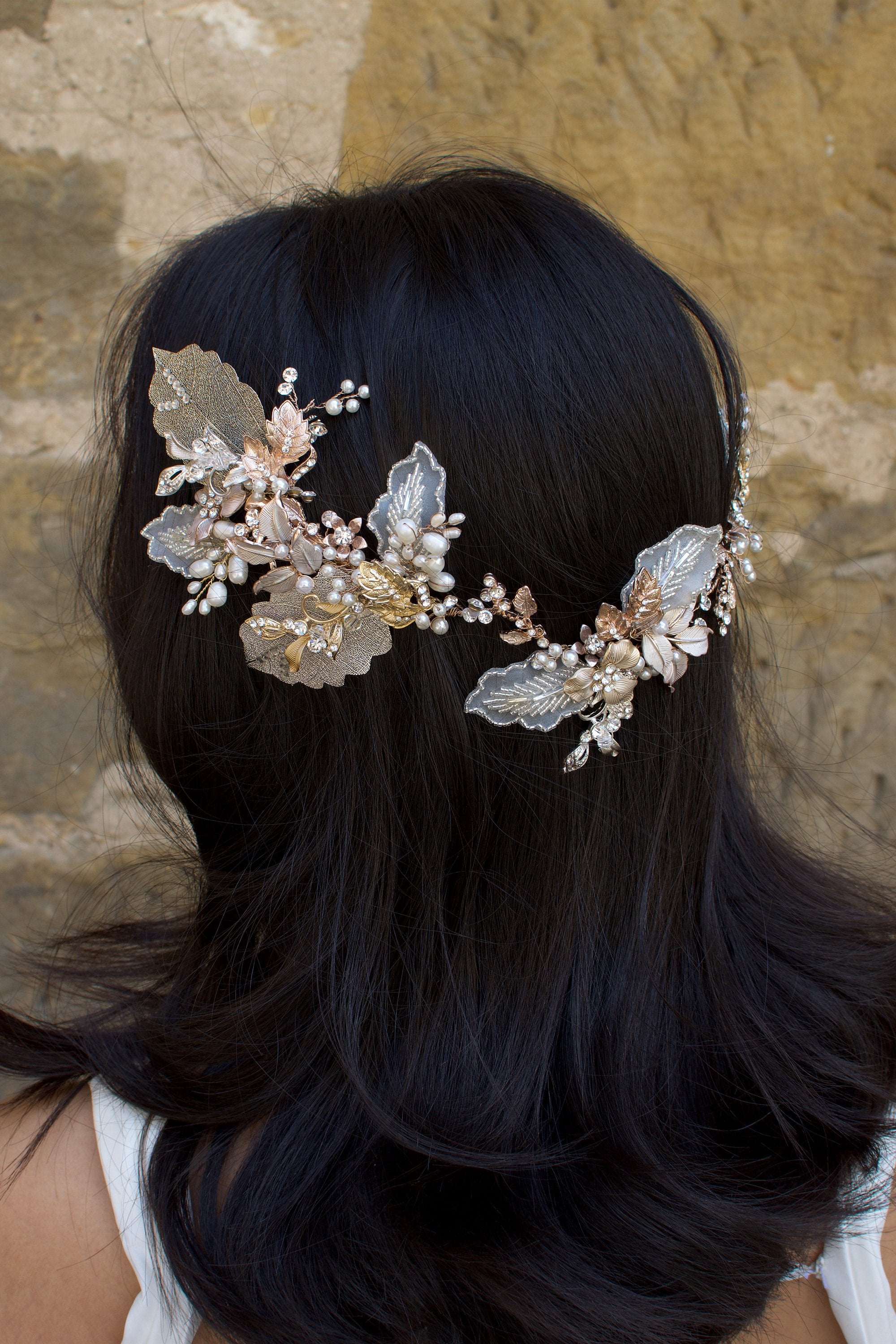 A dark haired model with hair down wears a Bridal Vine in Silver, Gold and Rose Gold