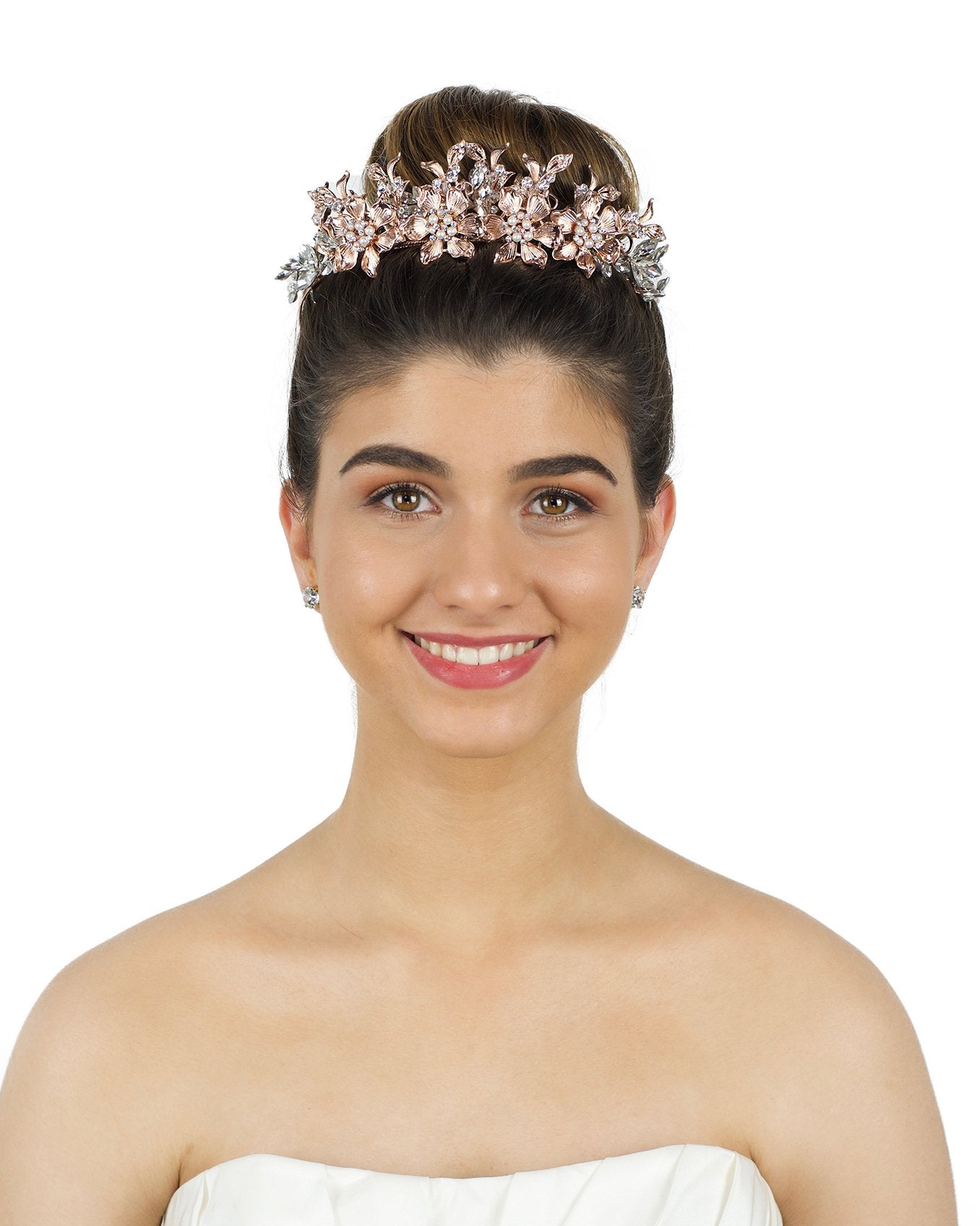 Pale Rose Gold Tiara of flowers and leaves worn by a smiling dark hair bride in front of a white backdrop