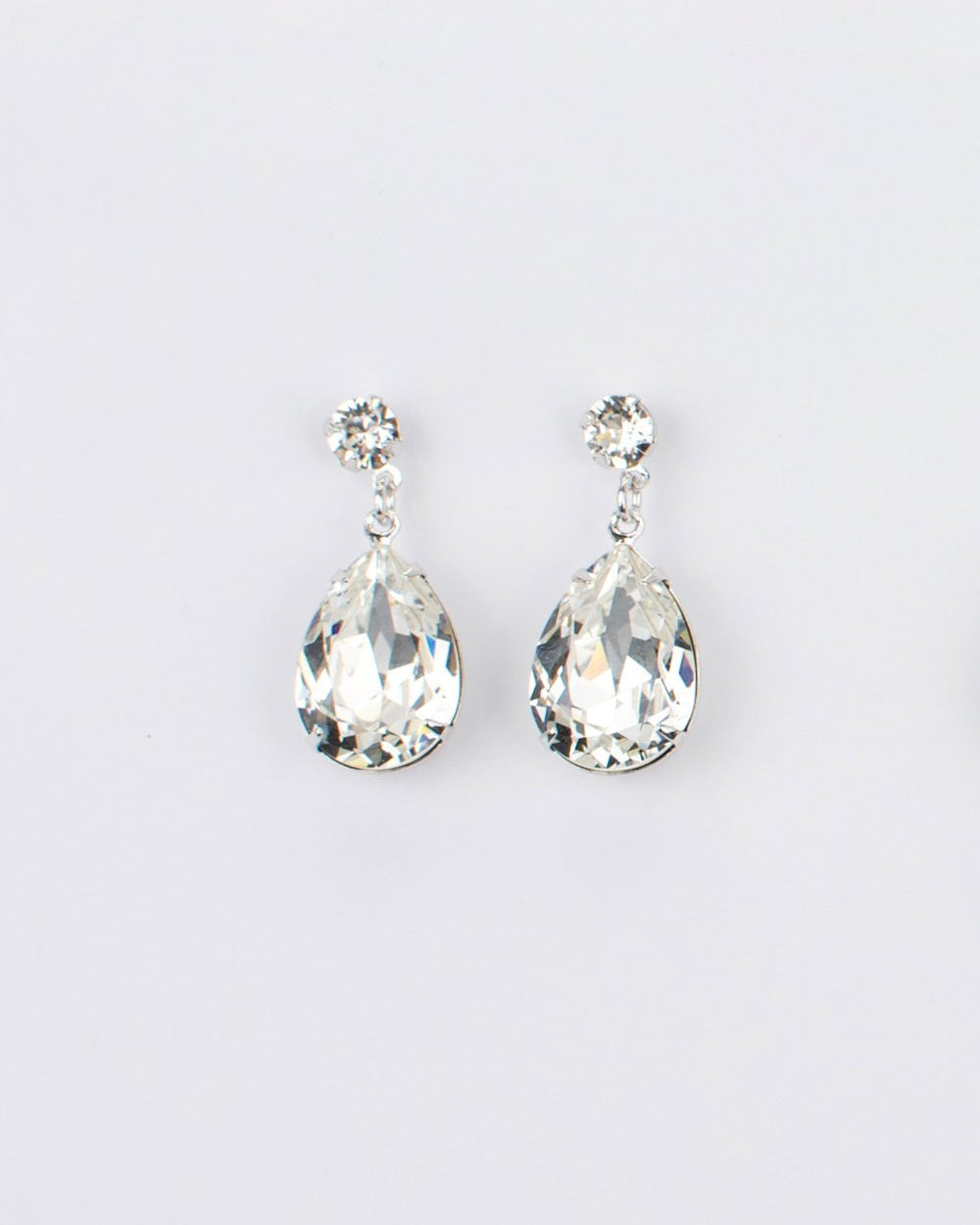 Bright Silver earring in a pear shape with clear swarovski stones