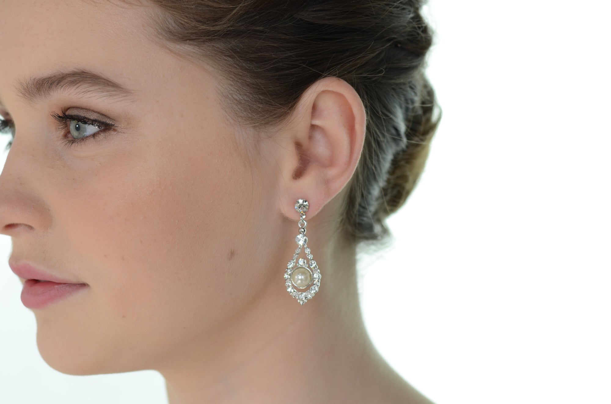 Close-up of a woman wearing a sparkling earring with a blurred background