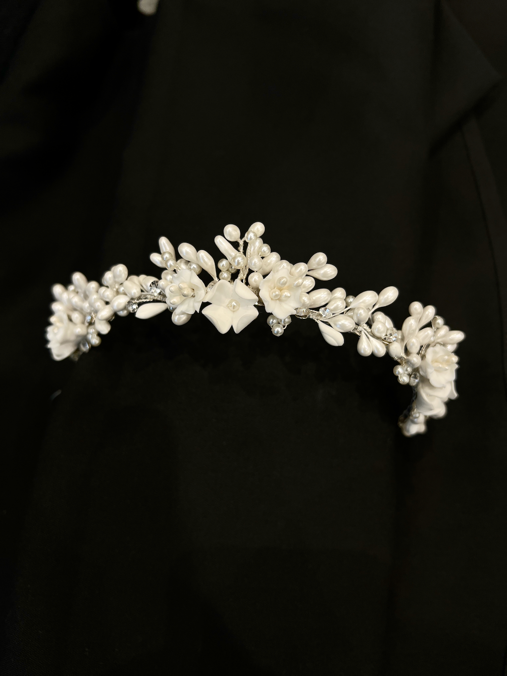 Silver tiara with floral design on a black background