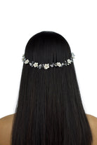 Model with long black hair wears a single strand flowers bridal vine with a white background