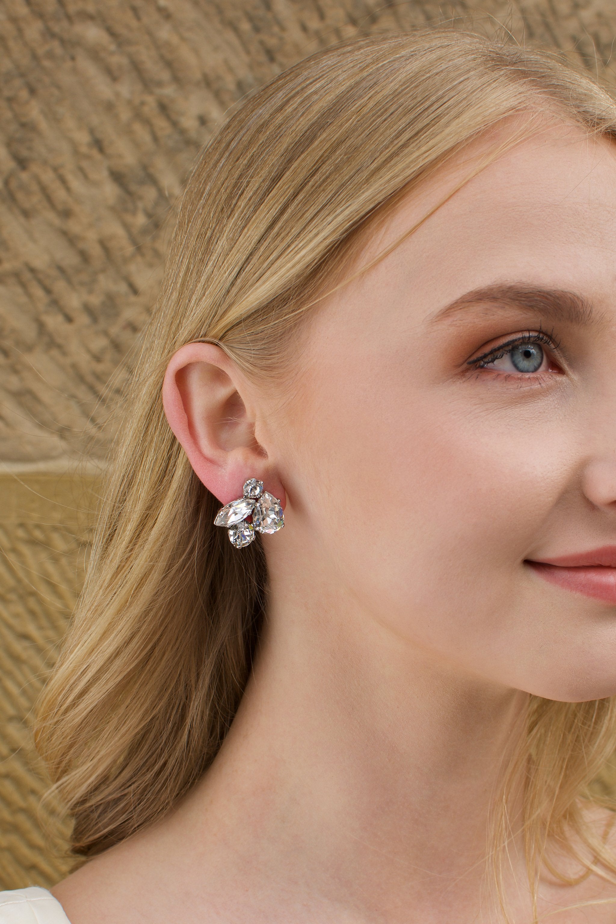 Swarovski Bridal Earring with stones of different shapes worn by a blonde bride