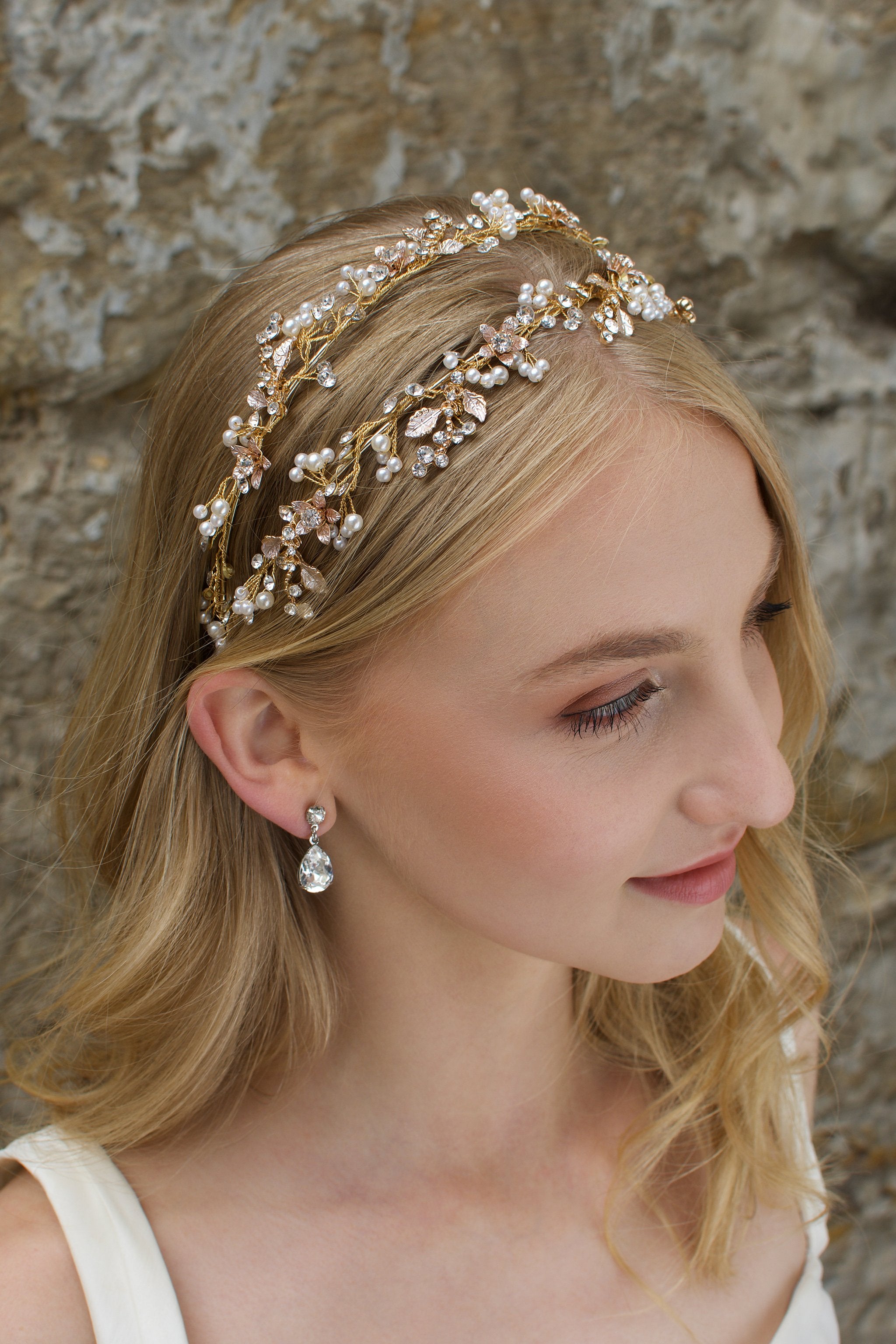 Blonde Bride wearing a Pale gold headband with a stones background